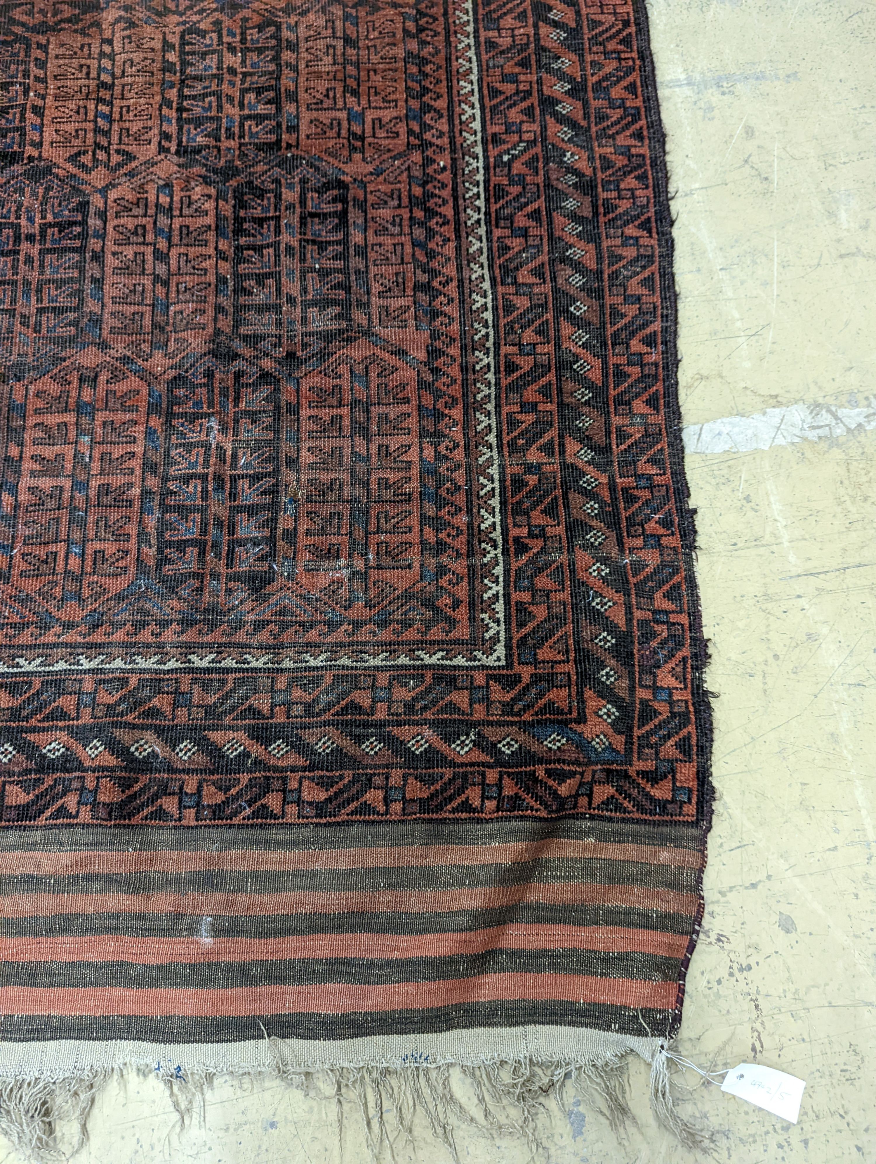 A Belouch red ground rug and a prayer rug, largest 178 x 106cm